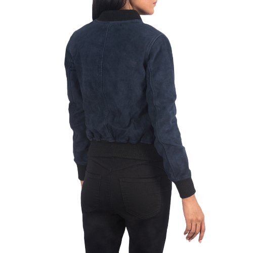 A woman with long dark hair, wearing a Zing Apparel Ava Ma-1 Suede Bomber Jacket in blue and black jeans, stands with her back to the camera against a white background.